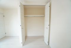 収納量たっぷりのクローゼット。ハンガーパイプ付で散らかりがちな洋服類もきれいに整理できます。使用頻度が少ないものは枕棚の上に、足元には3段ボックスを置いて、フル活用できるクローゼットです。